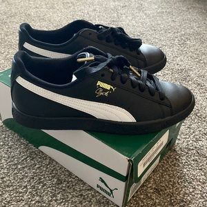 Black and white leather puma.